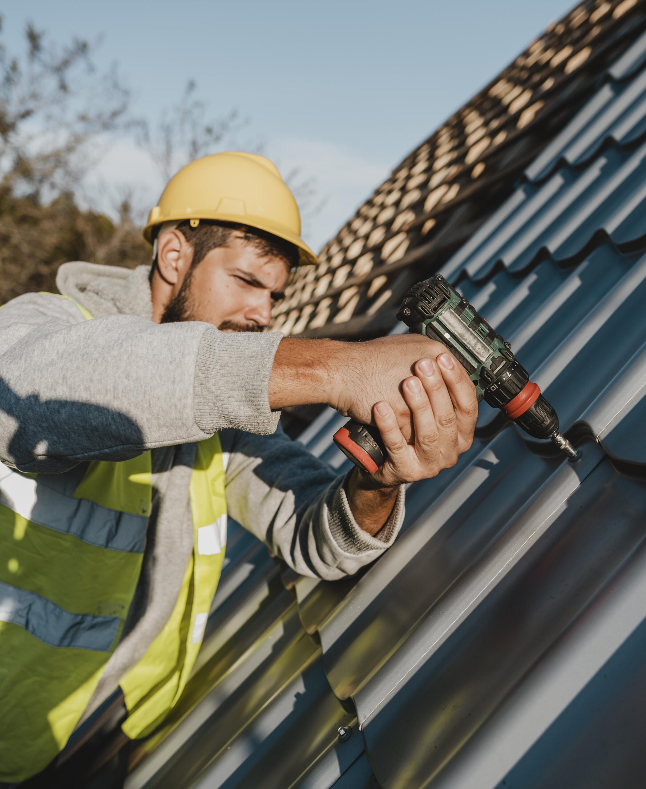 side-view-man-working-roof-with-drill